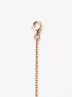 A close-up of a rose gold lobster clasp and extension chain, showing a 10K hallmark on the clasp, set against a plain white background.