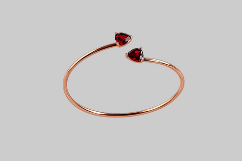 Ophelisse Solid 10k Rose gold bracelet bangle with heart-shaped natural  red garnet gemstones, on a gray background