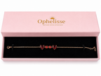 A solid 10k rose gold chain bracelet with two red heart-shaped and two round-shaped natural garnet gemstones, presented in an open light pink Ophelisse gift box with a black velvet interior.