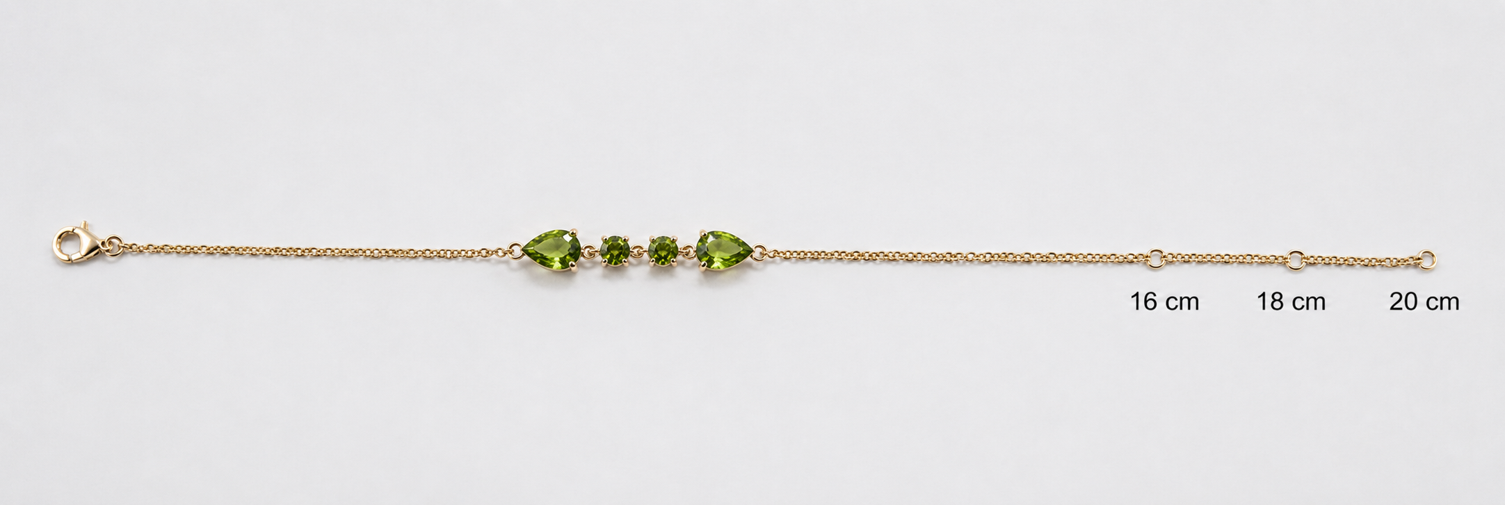 Ophelisse solid 10k yellow gold chain bracelet with two pear-shaped and two round-shaped natural green peridot gemstones with adjustable measurements