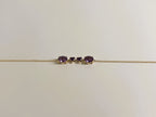 Ophelisse solid 10k yellow gold chain bracelet featuring two oval and two heart natural purple amethyst gemstones, shown closed up and side angle view against a plain off-white background.