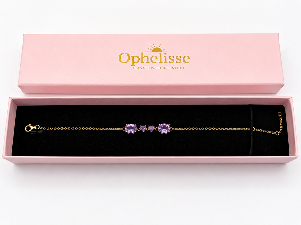 A solid 10k yellow gold chain bracelet with four natural purple amethyst gemstone clusters, presented in an open pink Ophelisse gift box with a black velvet interior.