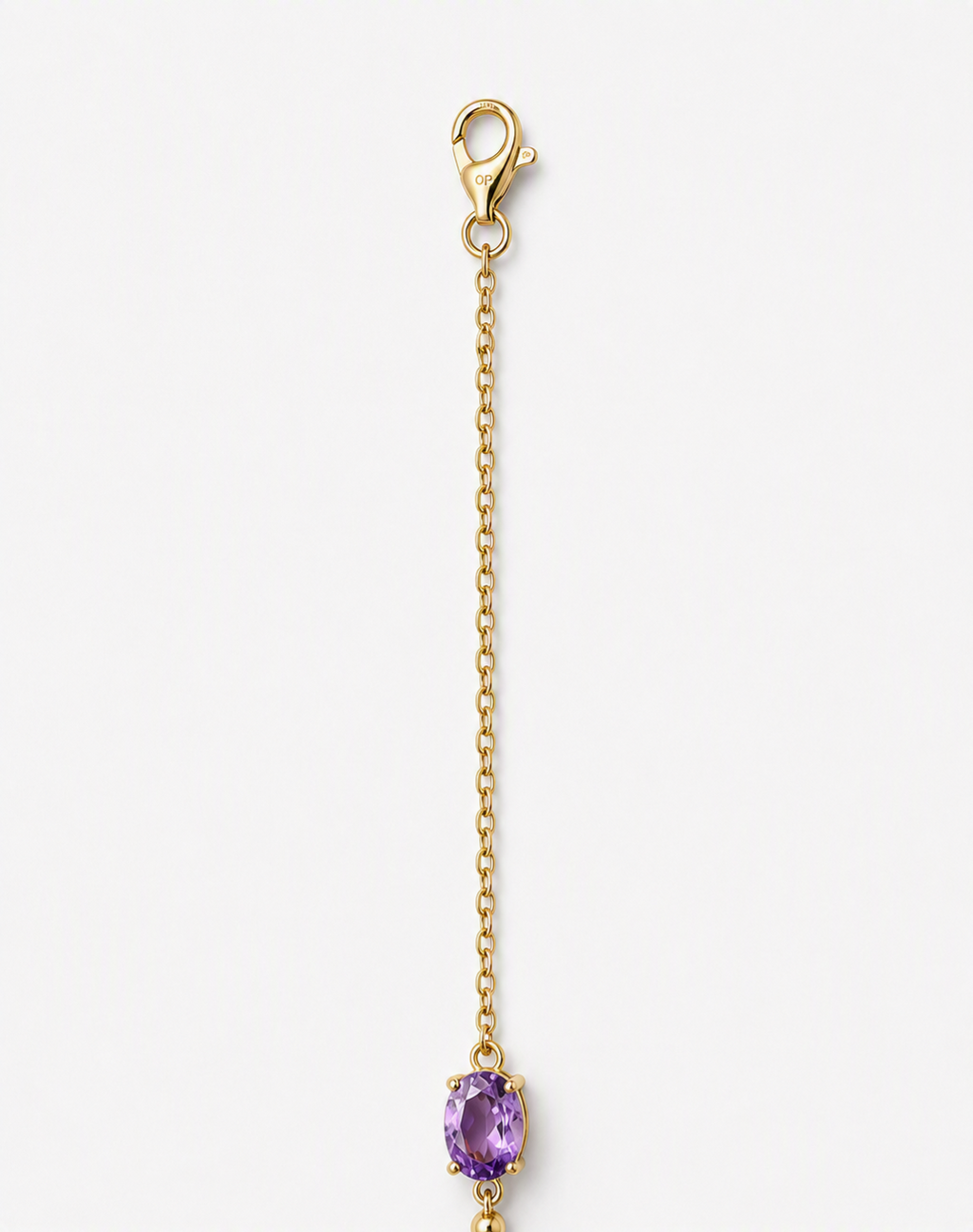 A part of a solid 10k yellow gold chain with a lobster clasp and an oval natural purple amethyst gemstone showing Ophelisse trademark, shown on a light gray background.