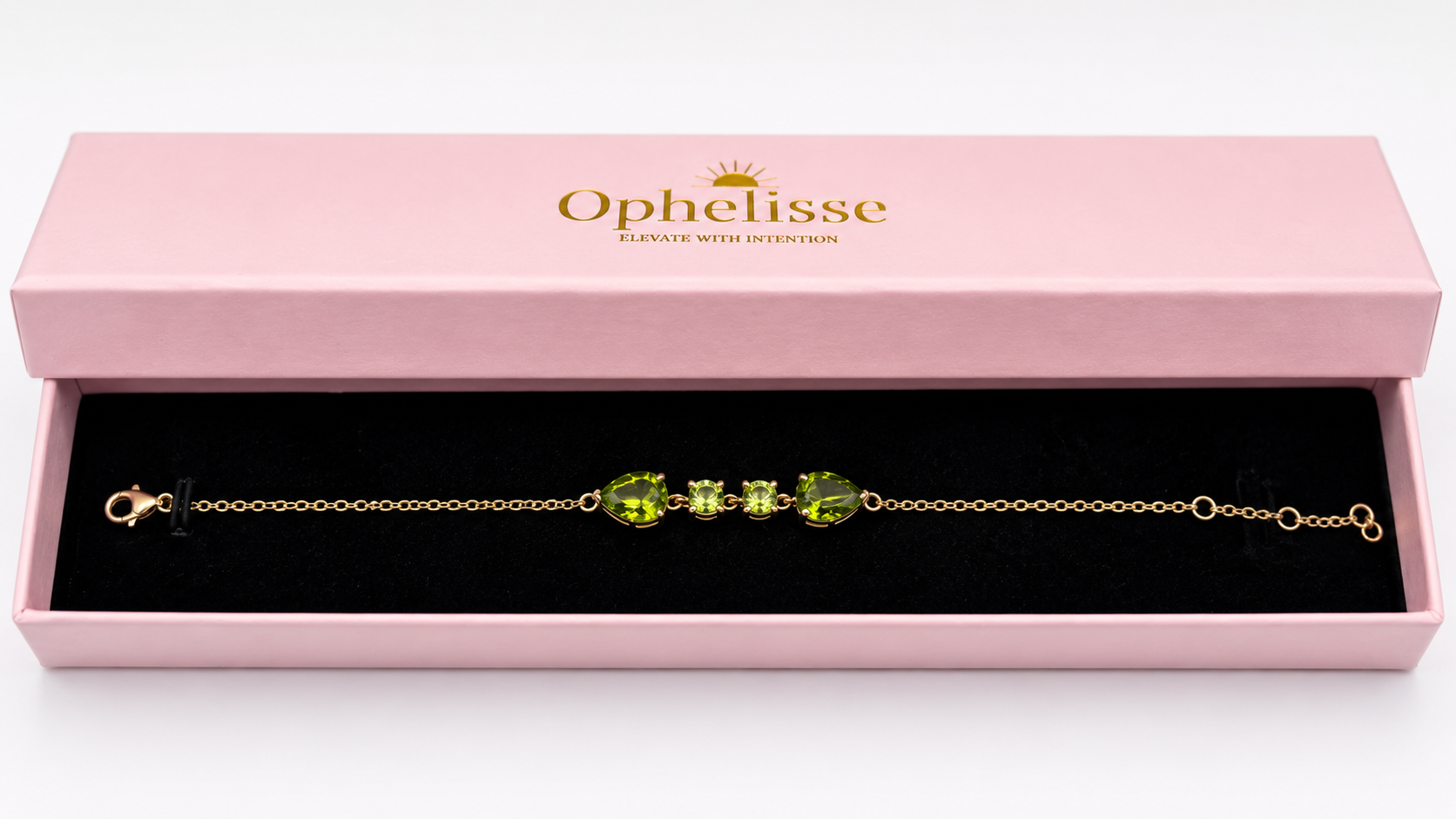 A solid 10k gold chain bracelet with natural green peridot gemstones, presented in a pink Ophelisse gift box with a black interior.